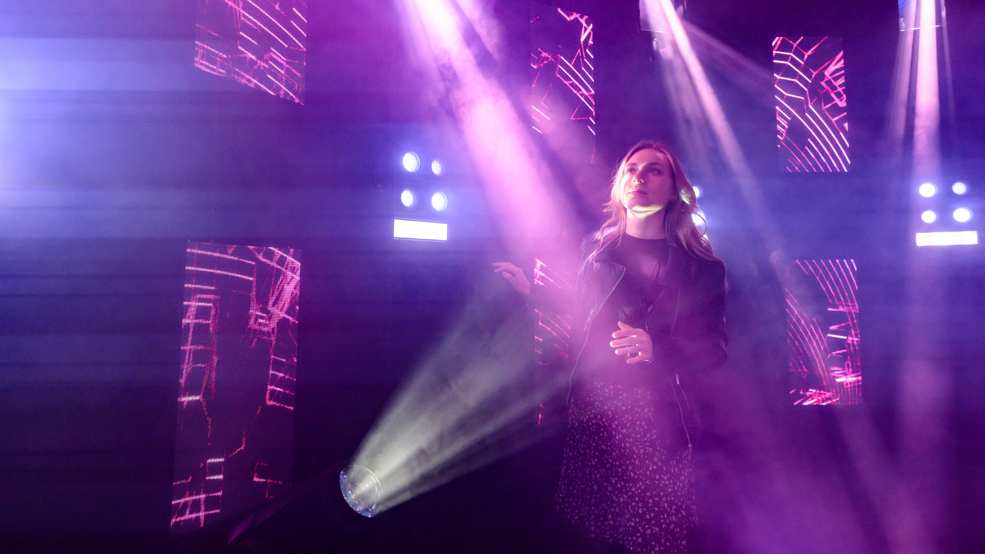 Woman dancing in purple spotlight